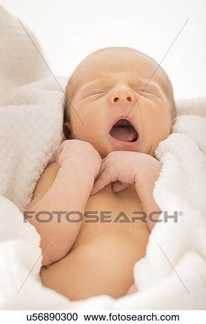 Stock Image - Newborn boy (0-1 month) yawning. Fotosearch