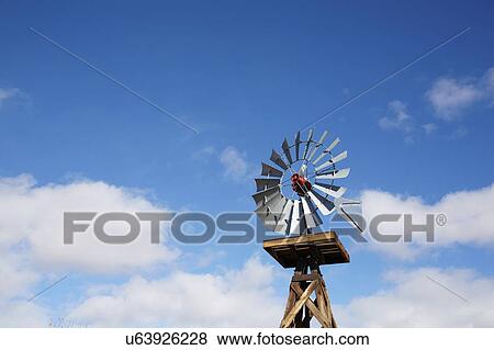 Stock Photo - Old windmill against cloudy sky. Fotosearch