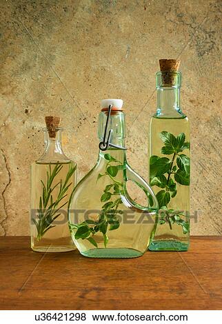 Olive oil bottles with mint, rosemary and oregano leaves View Large Photo Image Stock Photo - Olive oil bottles with mint, rosemary and oregano leaves. Fotosearch