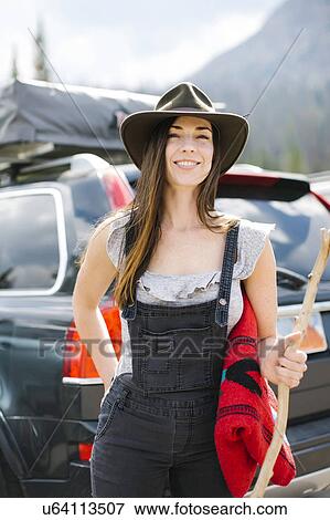 Stock Photo - Outdoor portrait of smiling woman wearing hat. Fotosearch