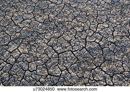 Stock Image - Overhead view of cracked desert. Fotosearch