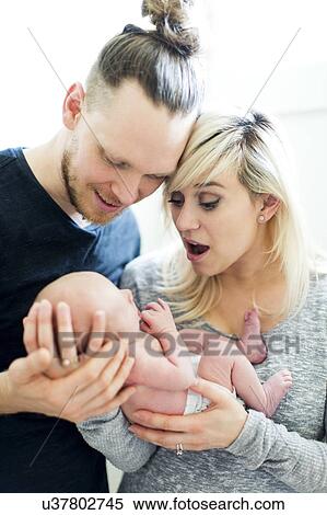 Stock Photography - Parents holding newborn (0-1 months). Fotosearch