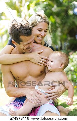 Parents with baby (18-23 months) in summer View Large Photo Image Stock Photograph - Parents with baby (18-23 months) in summer. Fotosearch