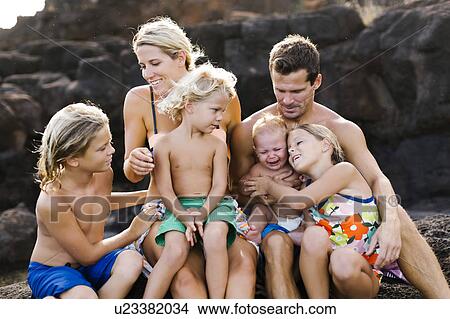 Parents with four children (12-17 months, 4-5, 6-7, 8-9) at beach View Large Photo Image Picture - Parents with four children (12-17 months, 4-5, 6-7, 8-9) at beach. Fotosearch