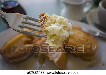 Stock Image - Piece of french toast on fork. Fotosearch