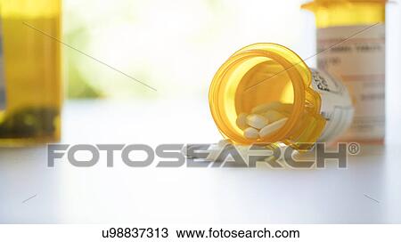 Stock Image - Pill bottles on table. Fotosearch
