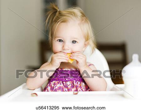 Portrait of baby girl (12-17 months) eating lunch View Large Photo Image Stock Photography - Portrait of baby girl (12-17 months) eating lunch. Fotosearch