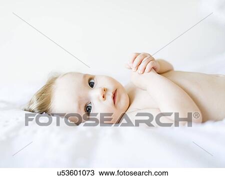 Stock Image - Portrait of baby girl (6-11 Months) looking at camera. Fotosearch