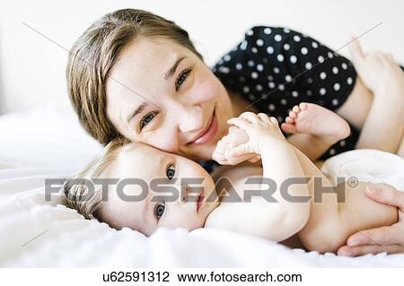 Portrait of baby girl (6-11 Months) with mother View Large Photo Image Stock Image - Portrait of baby girl (6-11 Months) with mother. Fotosearch