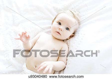 Stock Image - Portrait of baby girl (6-11 Months) directly above. Fotosearch