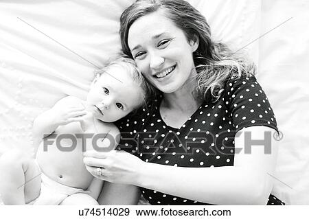 Portrait of baby girl (6-11 Months) with mother, directly above View Large Photo Image Stock Photo - Portrait of baby girl (6-11 Months) with mother, directly above. Fotosearch