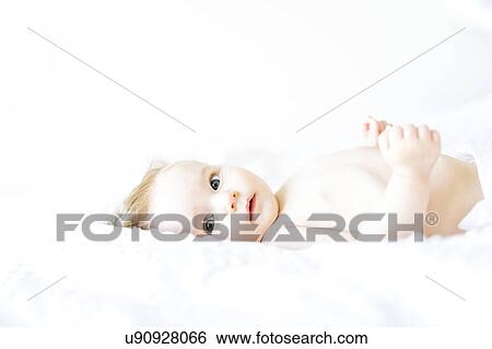Stock Photograph - Portrait of baby girl (6-11 Months) looking at camera. Fotosearch