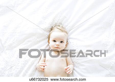 Stock Photography - Portrait of baby girl (6-11 Months) directly above. Fotosearch