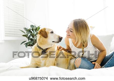Portrait of blond woman with golden retriever View Large Photo Image Picture - Portrait of blond woman with golden retriever. Fotosearch