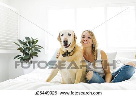 Stock Photography - Portrait of blond woman with golden retriever. Fotosearch