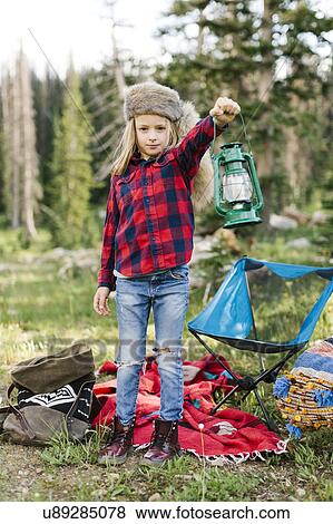 Stock Photo - Portrait of boy (6-7) with camping gear in forest. Fotosearch