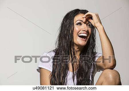 Stock Image - Portrait of brunette laughing. Fotosearch