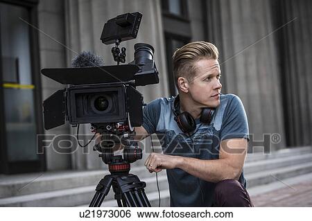 Portrait of camera operator looking away View Large Photo Image Stock Photograph - Portrait of camera operator looking away. Fotosearch