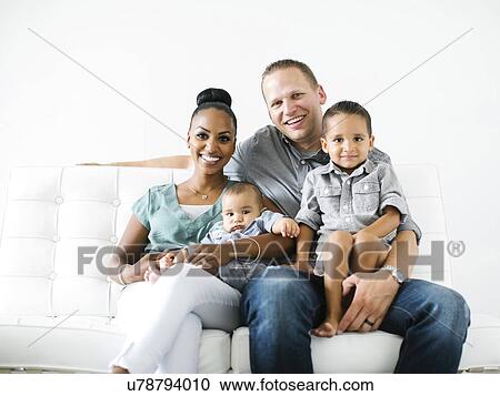 Stock Image - Portrait of family with two children (2-5 months, 2-3). Fotosearch