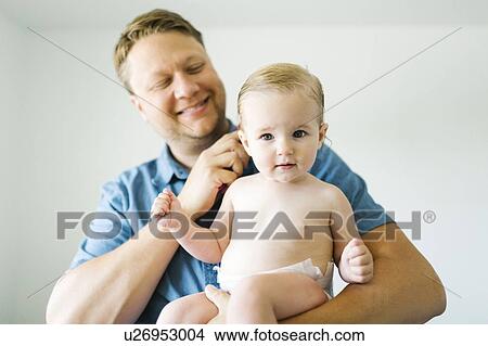 Picture - Portrait of father and baby girl (12-17 months) after bath. Fotosearch