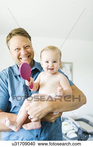 Portrait of father and baby girl (12-17 months) after bath View Large Photo Image Stock Image - Portrait of father and baby girl (12-17 months) after bath. Fotosearch