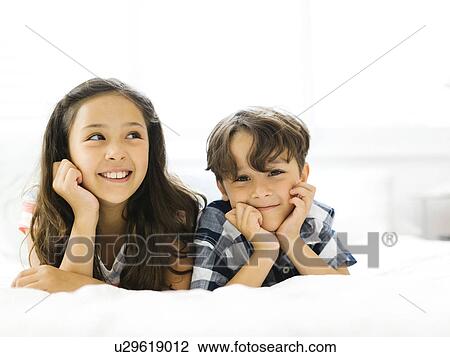 Stock Image - Portrait of girl (10-11) and boy (6-7). Fotosearch