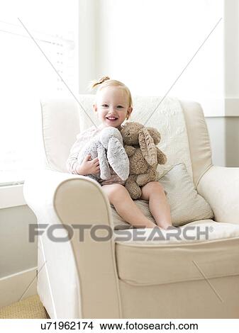 Portrait of girl ( 12-17 months ) holding stuffed toys View Large Photo Image Picture - Portrait of girl ( 12-17 months ) holding stuffed toys. Fotosearch