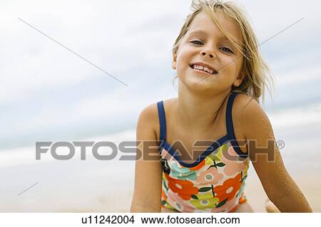 Portrait of girl (6-7) wearing swimming costume View Large Photo Image Picture - Portrait of girl (6-7) wearing swimming costume. Fotosearch