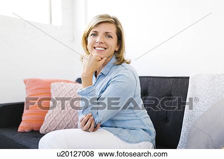 Stock Photo - Portrait of happy Mature woman with hand on chin. Fotosearch