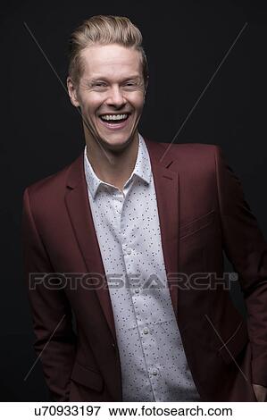 Stock Photo - Portrait of laughing man wearing maroon suit. Fotosearch