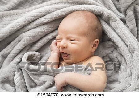 Portrait of little baby boy (0-1 months) wrapped in blanket View Large Photo Image Stock Image - Portrait of little baby boy (0-1 months) wrapped in blanket. Fotosearch