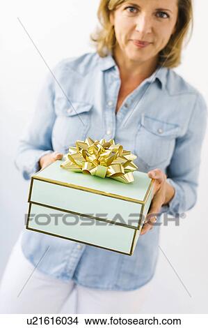 Portrait of Mature woman holding gift View Large Photo Image Picture - Portrait of Mature woman holding gift. Fotosearch