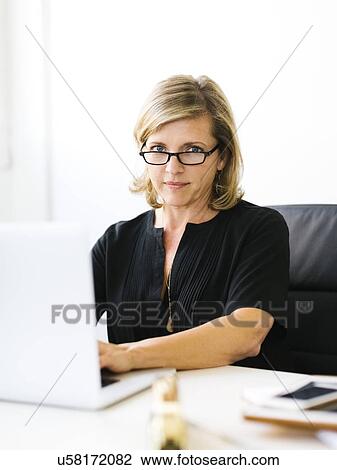 Stock Image - Portrait of Mature woman in eyeglasses. Fotosearch