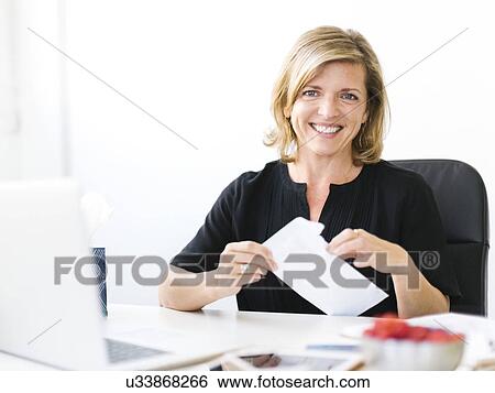 Portrait of Mature woman opening letter View Large Photo Image Stock Photograph - Portrait of Mature woman opening letter. Fotosearch