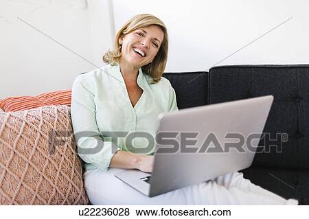 Portrait of Mature woman using computer View Large Photo Image Stock Photo - Portrait of Mature woman using computer. Fotosearch