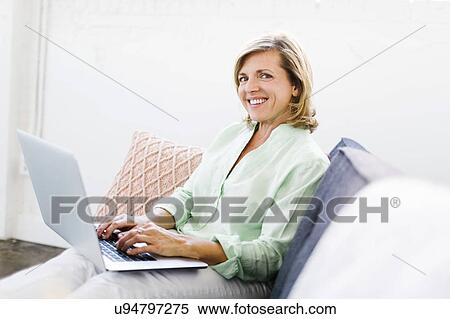 Stock Photography - Portrait of Mature woman using computer. Fotosearch