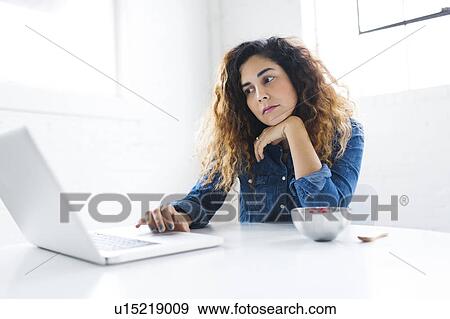 Portrait of mid adult woman using laptop View Large Photo Image Stock Photo - Portrait of mid adult woman using laptop. Fotosearch