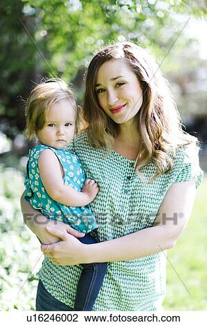 Portrait of mother and baby girl (12-17 months) in backyard View Large Photo Image Stock Image - Portrait of mother and baby girl (12-17 months) in backyard. Fotosearch