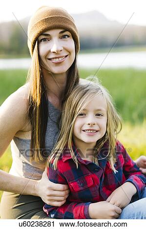 Stock Image - Portrait of mother and son (6-7) in meadow. Fotosearch