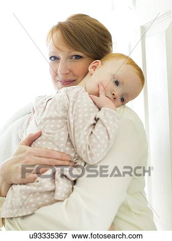 Portrait of mother embracing daughter ( 12-17 months ) View Large Photo Image Stock Photo - Portrait of mother embracing daughter ( 12-17 months ). Fotosearch