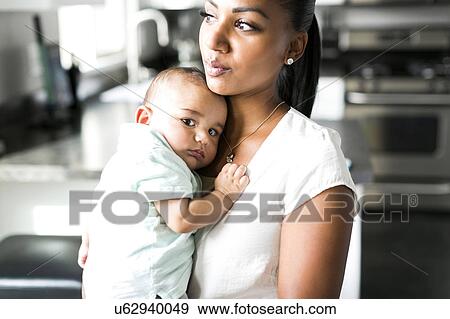 Portrait of mother holding baby boy (2-5 months) View Large Photo Image Stock Photo - Portrait of mother holding baby boy (2-5 months). Fotosearch