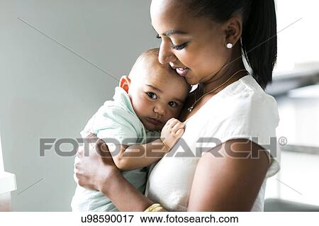 Portrait of mother holding baby boy (2-5 months) View Large Photo Image Stock Photo - Portrait of mother holding baby boy (2-5 months). Fotosearch