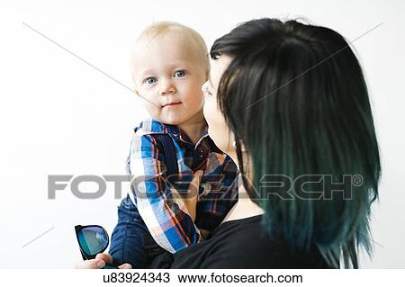 Portrait of mother holding son (12-17 months) against white background View Large Photo Image Stock Image - Portrait of mother holding son (12-17 months) against white background. Fotosearch