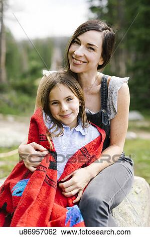Stock Image - Portrait of mother with daughter (8-9) in forest. Fotosearch