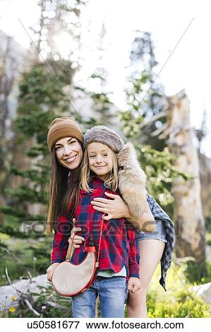 Stock Photo - Portrait of mother with son (6-7) hiking in forest. Fotosearch