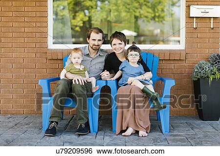 Portrait of parents with daughters (2-3, 12-17 months) View Large Photo Image Stock Photograph - Portrait of parents with daughters (2-3, 12-17 months). Fotosearch