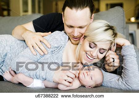 Stock Image - Portrait of parents with newborn boy ( 0-1 months ). Fotosearch