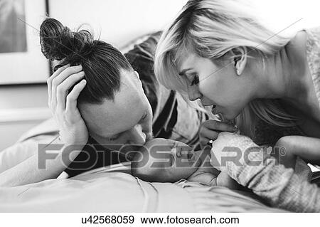 Stock Photo - Portrait of parents with newborn boy ( 0-1 months ). Fotosearch