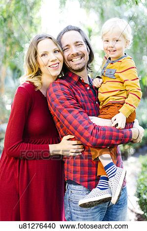 Portrait of parents with son (4-5) in park View Large Photo Image Stock Image - Portrait of parents with son (4-5) in park. Fotosearch