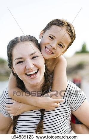 Stock Image - Portrait of smiling mother with son (6-7). Fotosearch